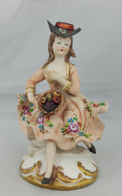 Capodimonte Figurine Seated Girl with Fruit Basket - Minor Chip