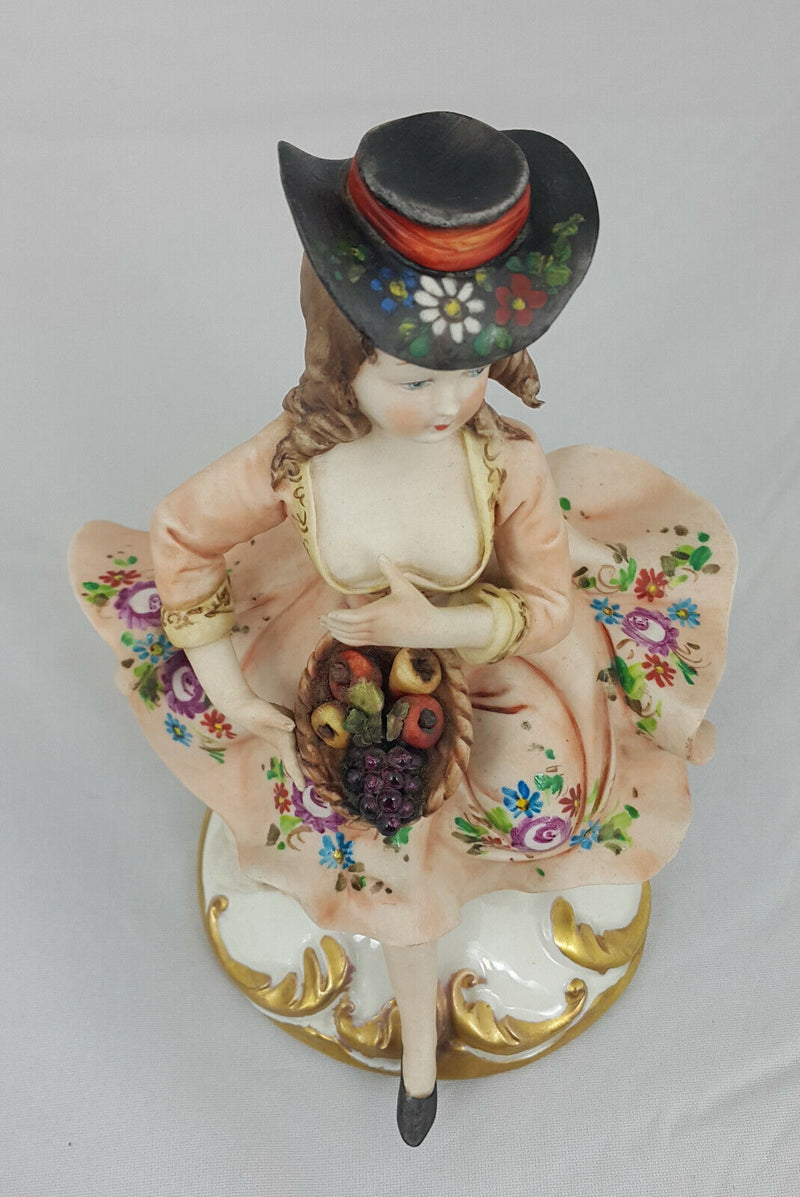 Capodimonte Figurine Seated Girl with Fruit Basket - Minor Chip