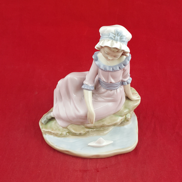 Nao By Lladro - Girl Sitting On The Edge Of Water With Floating Boat - L/N 2035