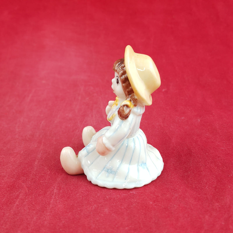 Royal Copenhagen Miniature Child Figure - Seated Doll 141 - RCH 2052