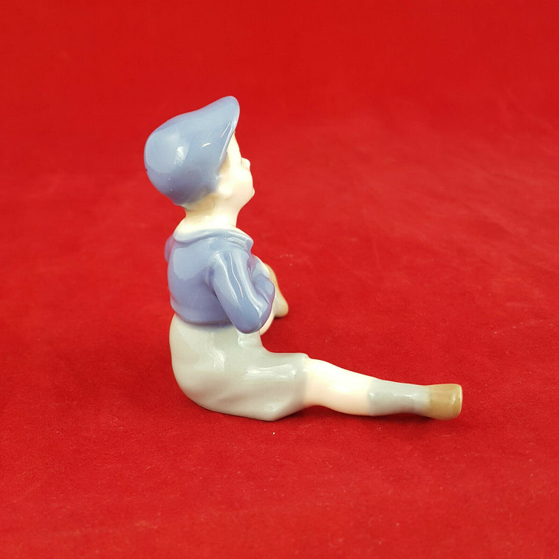 Unmarked Porcelain Figurine - Boy Sitting - NA 754