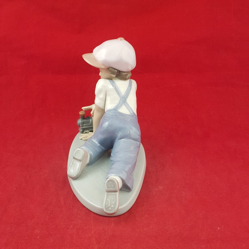 Lladro Figurine 7619 - All Aboard Boy Playing with Train - 7568 L/N